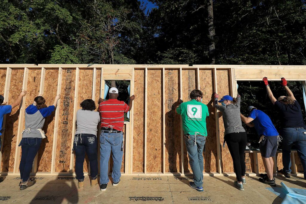 Volunteers help at a Habitat for Humanity home