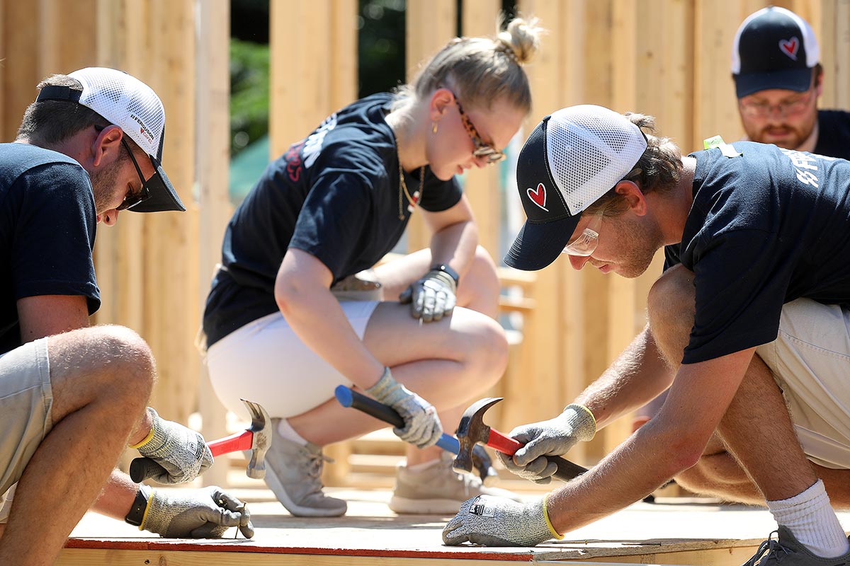 Volunteers from Ferguson Enterprises help put up the walls of a Habitat for Humanity home in Hampton Thursday June 30, 2022.