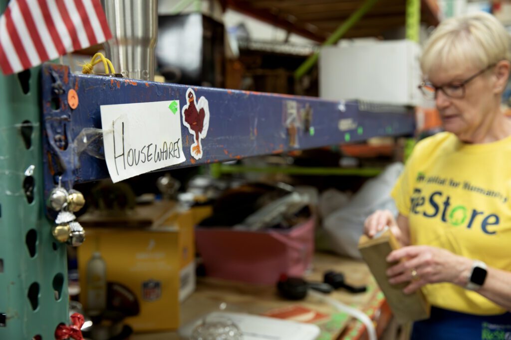 Debbie Hill sorting wooden ornaments at the Habitat ReStore.