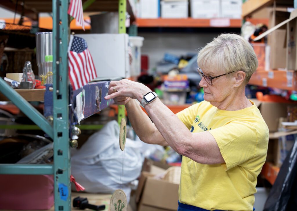 Debbie Hill volunteers at the Habitat Williamsburg ReStore, organizing donated items.