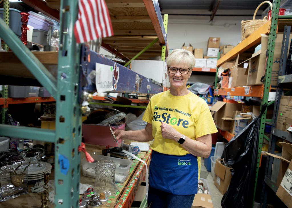 Debbie Hill smiling while volunteering at the Williamsburg Habitat ReStore.