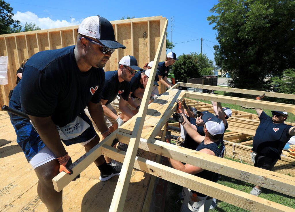 Ferguson executive joins roof construction team at Habitat.