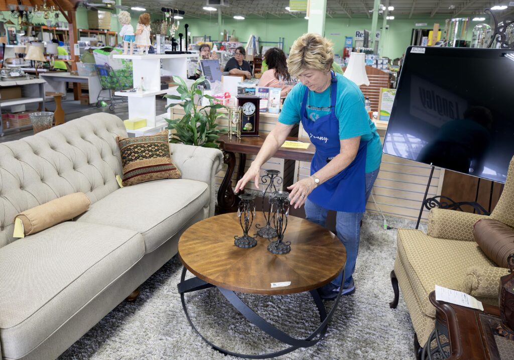 Jenny McCauley arranges furniture pieces into a stylish vignette at the ReStore.