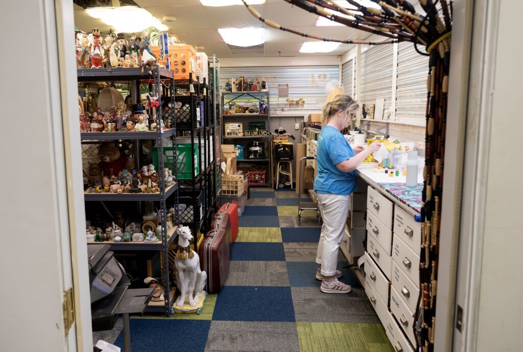 Nancy organizing donated items in the ReStore room.