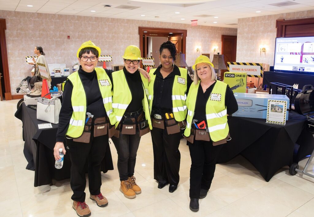 People posing in construction outfits.