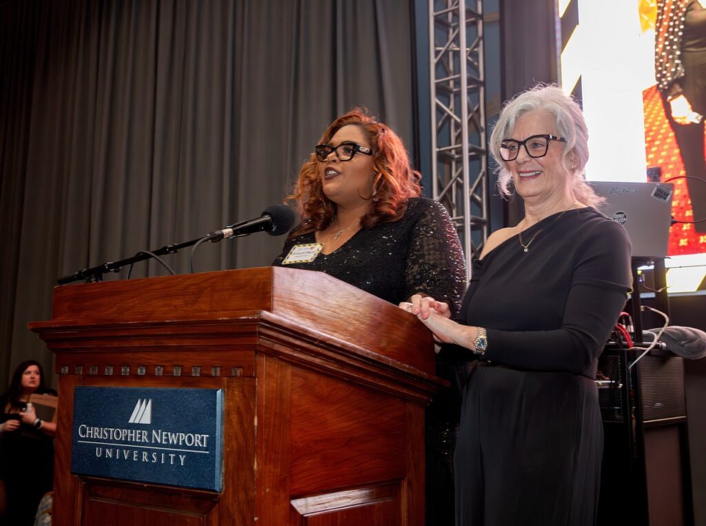 Two people on stage at a podium.