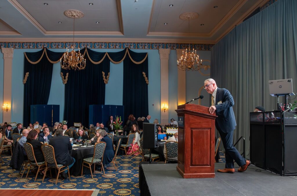 Habitat for Humanity Peninsula and Greater Williamsburg Board Chair on stage. 