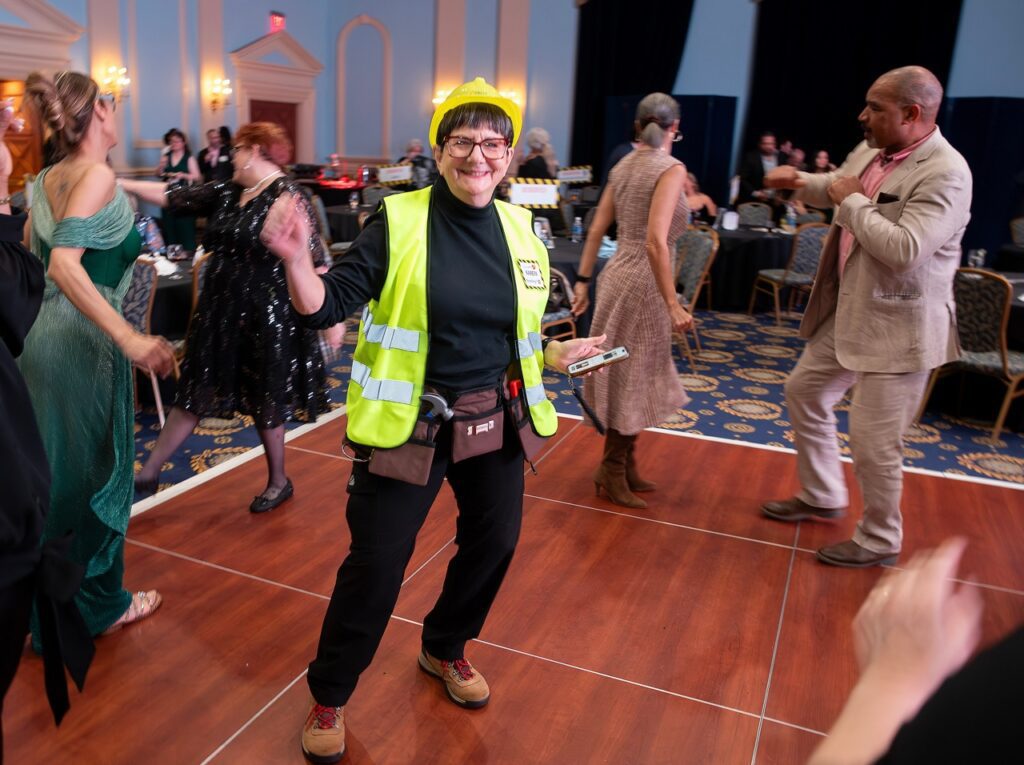 Woman in construction outfit dancing. 