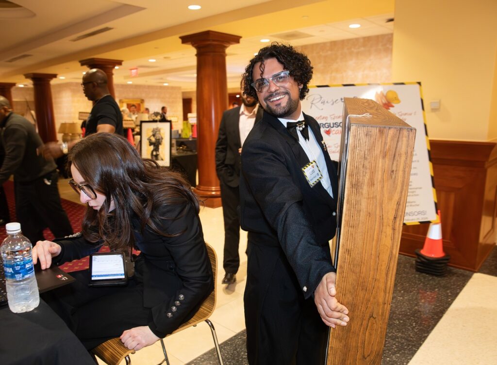 Habitat for Humanity worker moving a box. 