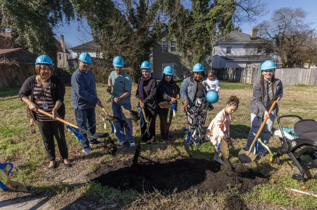 People breaking ground with shovels at habitat ceremony