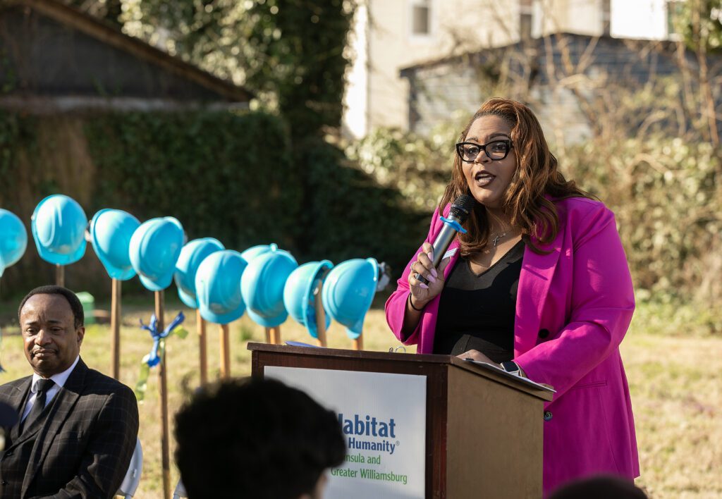 Habitat for Humanity Peninsula and Greater Williamsburg President and CEO speaking at a ceremony.