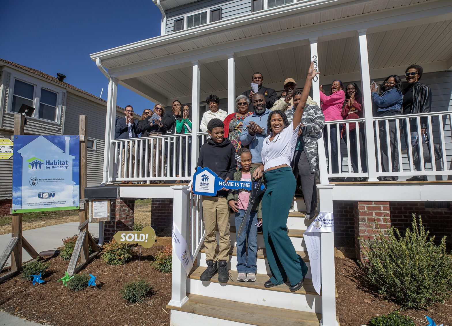 People standing on porch of Habitat for Humanity home