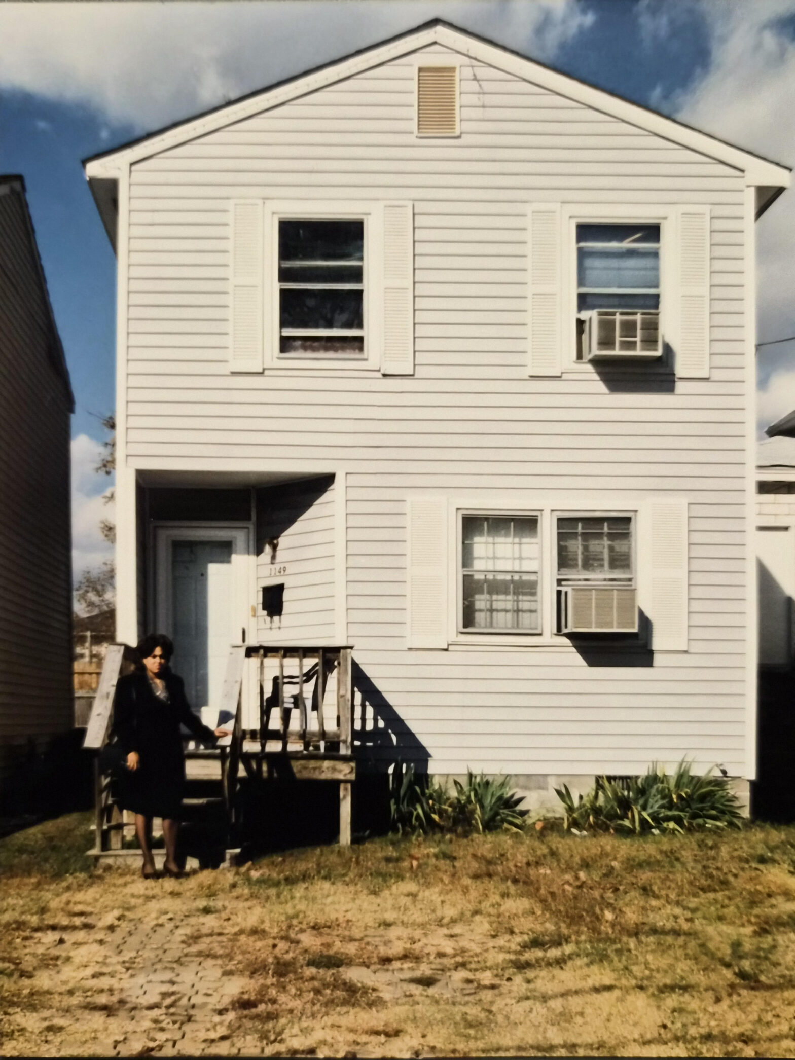 Woman standing in front of house