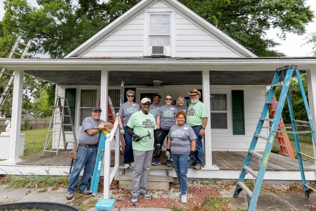 Team of people outside a house 