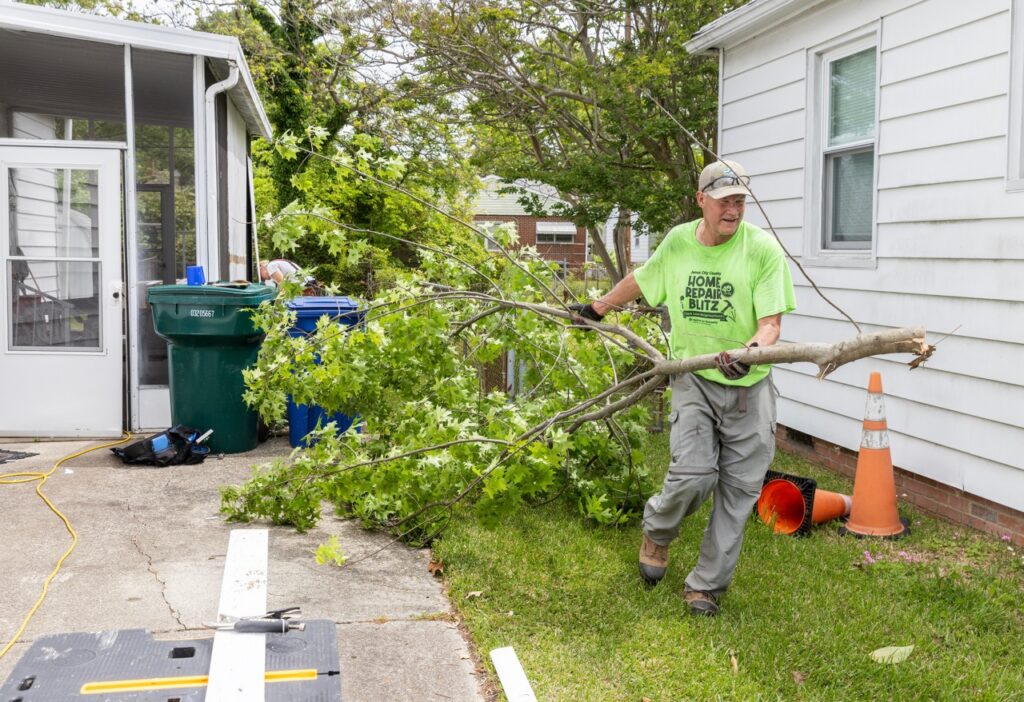 Man holding a tree walking 