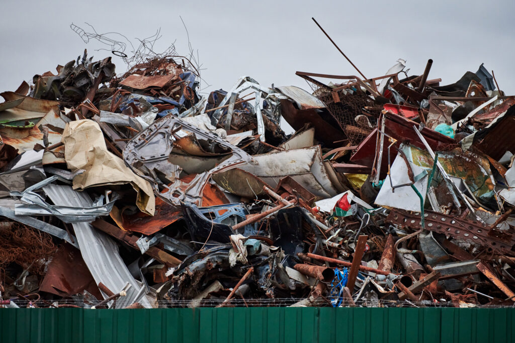 Piles of scrap metal at a dump.