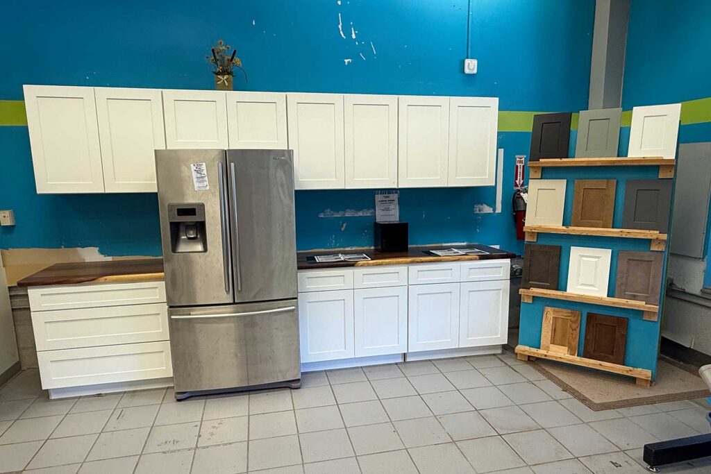 A modern kitchen featuring a refrigerator and wooden cabinets, showcasing a clean and organized cooking space.